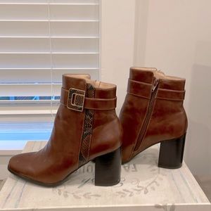 Classic brown boots with snakeskin and buckle accent.